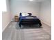 Cozy bedroom with carpet and a dark metal bed frame at 109 W Poplar St, Stanley, NC 28164