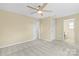 Bedroom features carpeted floors, ceiling fan, and access to an ensuite bathroom and closet at 109 W Poplar St, Stanley, NC 28164