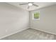 Empty bedroom featuring neutral walls, carpet flooring, a window and a ceiling fan at 109 W Poplar St, Stanley, NC 28164
