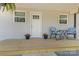 Close-up of the porch featuring chairs and potted plants on the wooden deck at 109 W Poplar St, Stanley, NC 28164