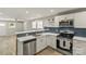 Modern kitchen features stainless steel appliances, granite countertops, and a stylish blue backsplash at 109 W Poplar St, Stanley, NC 28164