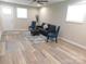 Bright living room features wood-look flooring, modern furnishings, and ample natural light at 109 W Poplar St, Stanley, NC 28164