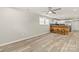 Open-concept living space with hardwood floors, sleek ceiling fan, and natural light, seamlessly connecting to the kitchen at 109 W Poplar St, Stanley, NC 28164