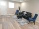 Bright living room features wood-look flooring, modern furnishings, and ample natural light at 109 W Poplar St, Stanley, NC 28164