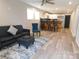 Open-concept living room featuring modern vinyl flooring, stylish furniture, and natural light at 109 W Poplar St, Stanley, NC 28164