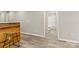 An open-concept living space leading to the bathroom with hardwood floors at 109 W Poplar St, Stanley, NC 28164