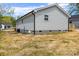 View of backyard and the rear of the house showing a recently added deck at 109 W Poplar St, Stanley, NC 28164