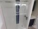 Modern shower with white tiled walls and a contrasting blue decorative stripe at 109 W Poplar St, Stanley, NC 28164