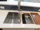 Modern kitchen sink featuring a stainless steel finish, cutting board, and sleek design at 109 W Poplar St, Stanley, NC 28164