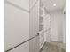Spacious walk-in closet with built-in shelving, drawers, and multiple clothing rods for optimal storage at 109 W Poplar St, Stanley, NC 28164