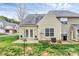 Back exterior featuring a small patio, verdant lawn, perfect for enjoying the outdoors at 11539 Delores Ferguson Ln, Charlotte, NC 28277