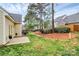 Lush backyard with a small patio, verdant lawn, and mature trees, perfect for outdoor enjoyment at 11539 Delores Ferguson Ln, Charlotte, NC 28277