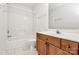 Bathroom featuring a shower-tub combo, oak cabinets, and vanity at 11539 Delores Ferguson Ln, Charlotte, NC 28277