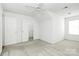 Cozy bedroom with neutral carpet, two closets, and an overhead ceiling fan at 11539 Delores Ferguson Ln, Charlotte, NC 28277