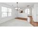 Open dining area adjacent to the kitchen with natural light from a window and hardwood flooring at 11539 Delores Ferguson Ln, Charlotte, NC 28277