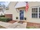 Inviting front entrance with a navy door, cheerful flower pots, and a 'Welcome' mat at 11539 Delores Ferguson Ln, Charlotte, NC 28277