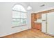 Bright kitchen with wooden cabinets, modern appliances, an arched window, and hardwood flooring at 11539 Delores Ferguson Ln, Charlotte, NC 28277