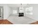 Bright and airy living room showcases a fireplace, modern light fixture, and access to the back patio at 11539 Delores Ferguson Ln, Charlotte, NC 28277