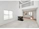 Inviting living room with a cozy fireplace and an open floor plan to the second story and kitchen at 11539 Delores Ferguson Ln, Charlotte, NC 28277