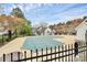 A covered community pool surrounded by a fence and trees at 11539 Delores Ferguson Ln, Charlotte, NC 28277