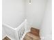 White staircase with wood handrail and wood flooring at 11539 Delores Ferguson Ln, Charlotte, NC 28277