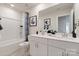 Bathroom featuring a double vanity with modern fixtures, a bathtub, and stylish accents at 117 Vaquaro Dr, Mooresville, NC 28115