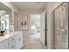 Bathroom view showing vanity, open doorway to bedroom, and glass-enclosed shower at 117 Vaquaro Dr, Mooresville, NC 28115