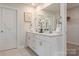 Elegant bathroom featuring a double vanity, white cabinets, and decorative floral accents at 117 Vaquaro Dr, Mooresville, NC 28115