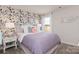 Stylish bedroom featuring a floral accent wall, complemented by a plush bed and matching side table at 117 Vaquaro Dr, Mooresville, NC 28115