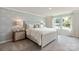 Bright bedroom with patterned accent wall, neutral decor, and ample natural light from two windows at 117 Vaquaro Dr, Mooresville, NC 28115