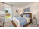 Serene bedroom with a cozy bed, a window with a view, and decorative wall art at 117 Vaquaro Dr, Mooresville, NC 28115