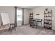 Bright hobby room with a crafting table, storage shelves, and a stool by the window at 117 Vaquaro Dr, Mooresville, NC 28115
