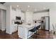 Modern kitchen with stainless steel appliances, white cabinets, a central island, and bar stool seating at 117 Vaquaro Dr, Mooresville, NC 28115