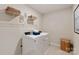 Well-lit laundry room with modern appliances, shelving, and tile flooring at 117 Vaquaro Dr, Mooresville, NC 28115