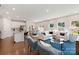 Spacious open-concept living area that combines the kitchen, dining room, and seating area. Hardwood floors throughout at 117 Vaquaro Dr, Mooresville, NC 28115