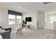 Comfortable living room features a plush gray sofa, a stylish coffee table, and a large window at 117 Vaquaro Dr, Mooresville, NC 28115
