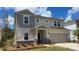 Charming two-story home featuring a two-car garage and landscaped front yard at 121 Vaquaro Dr, Mooresville, NC 28115