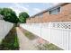 Fenced backyard featuring brick townhomes and some landscaping at 1218 Green Oaks Ln # E, Charlotte, NC 28205
