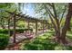 Community pergola with swing surrounded by grass and trees at 1218 Green Oaks Ln # E, Charlotte, NC 28205