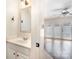 Cozy half bathroom with white vanity, framed mirror and an adjoining room with hardwood floors and white French doors at 1218 Green Oaks Ln # E, Charlotte, NC 28205