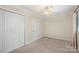 Neutral bedroom with a ceiling fan, closet, and window bringing in natural light at 1218 Green Oaks Ln # E, Charlotte, NC 28205