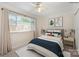 A staged bedroom features a large window, neutral colors, and comfortable furnishings at 1218 Green Oaks Ln # E, Charlotte, NC 28205