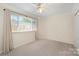 Bright bedroom with a ceiling fan and large window providing great natural light at 1218 Green Oaks Ln # E, Charlotte, NC 28205