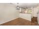 Open dining area features hardwood floors and adjacent view to kitchen area at 1218 Green Oaks Ln # E, Charlotte, NC 28205