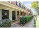 Brick townhomes with covered entryways and landscaped bushes at 1218 Green Oaks Ln # E, Charlotte, NC 28205