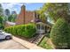 Brick townhome with covered porch and trimmed hedges at 1218 Green Oaks Ln # E, Charlotte, NC 28205