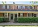 Brick townhome exteriors featuring covered entryways and bushes at 1218 Green Oaks Ln # E, Charlotte, NC 28205