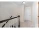 Bright hallway features fresh paint, carpet and a white door with a black handrail at 1218 Green Oaks Ln # E, Charlotte, NC 28205