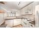 Kitchen features white appliances, granite countertops, and opens to the dining and living spaces at 1218 Green Oaks Ln # E, Charlotte, NC 28205