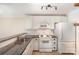 Contemporary kitchen features white appliances, granite counters, tile floors, and a breakfast bar at 1218 Green Oaks Ln # E, Charlotte, NC 28205